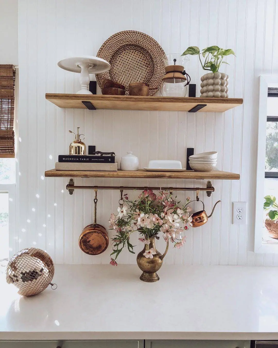 Brass Watering Can Holds A Bouquet Of Pink Flowers