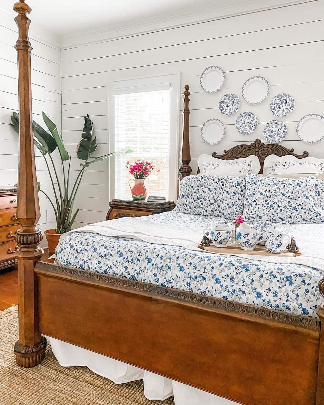 Blue and White Plates Create a Gallery Wall Above the Bed