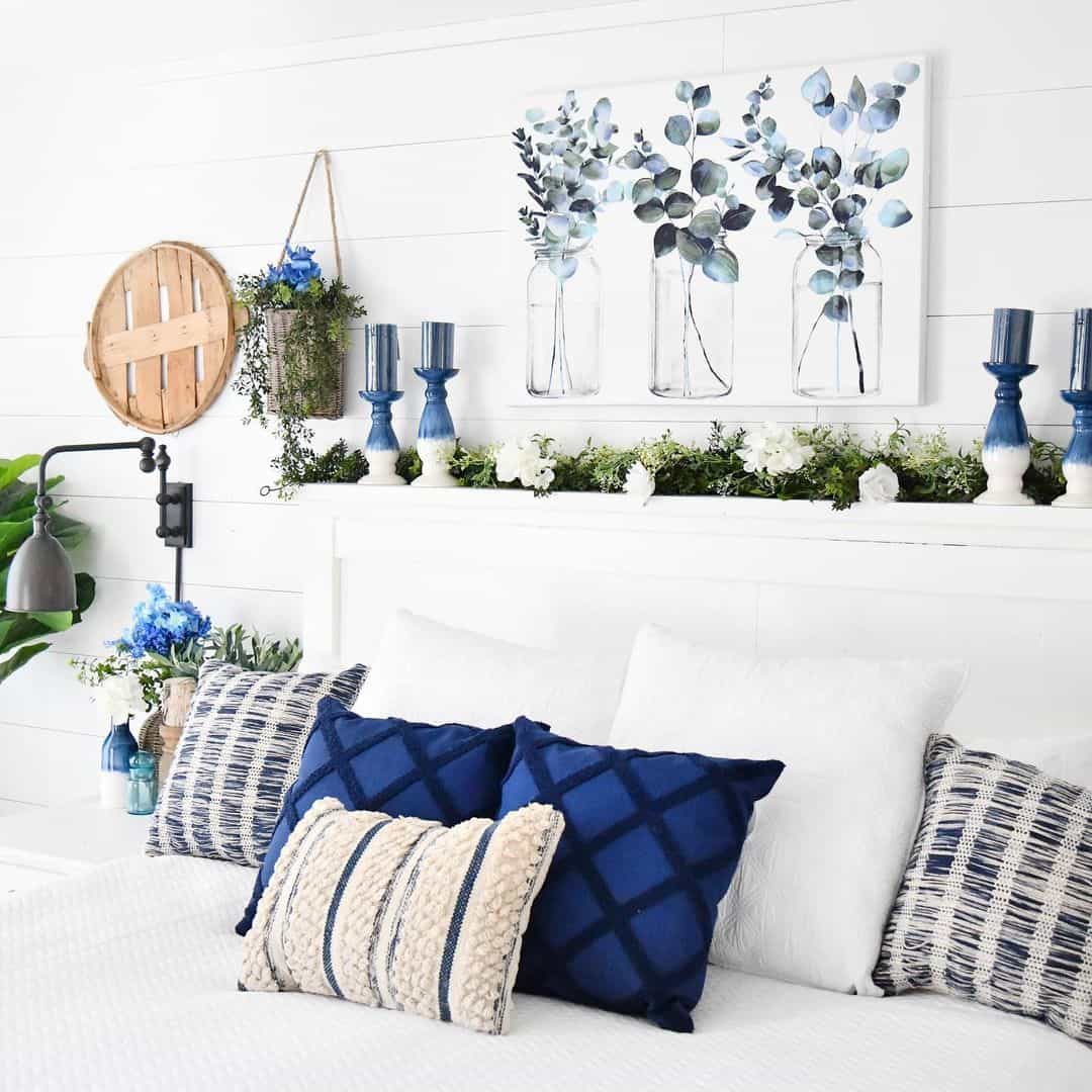 Blue and White Artwork and Garland Frame a Headboard