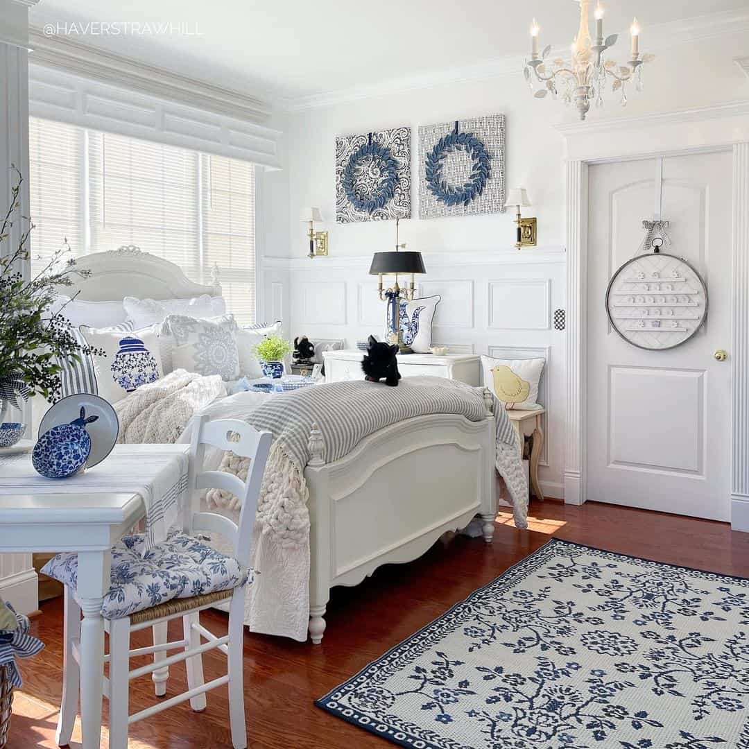 Two Blue and White Wreath Art Pieces Add Pattern Above the Bed