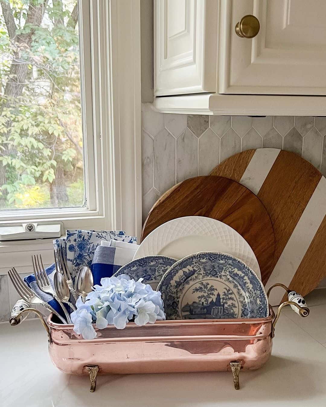Copper Basin Displays Blue and White Plates with Florals