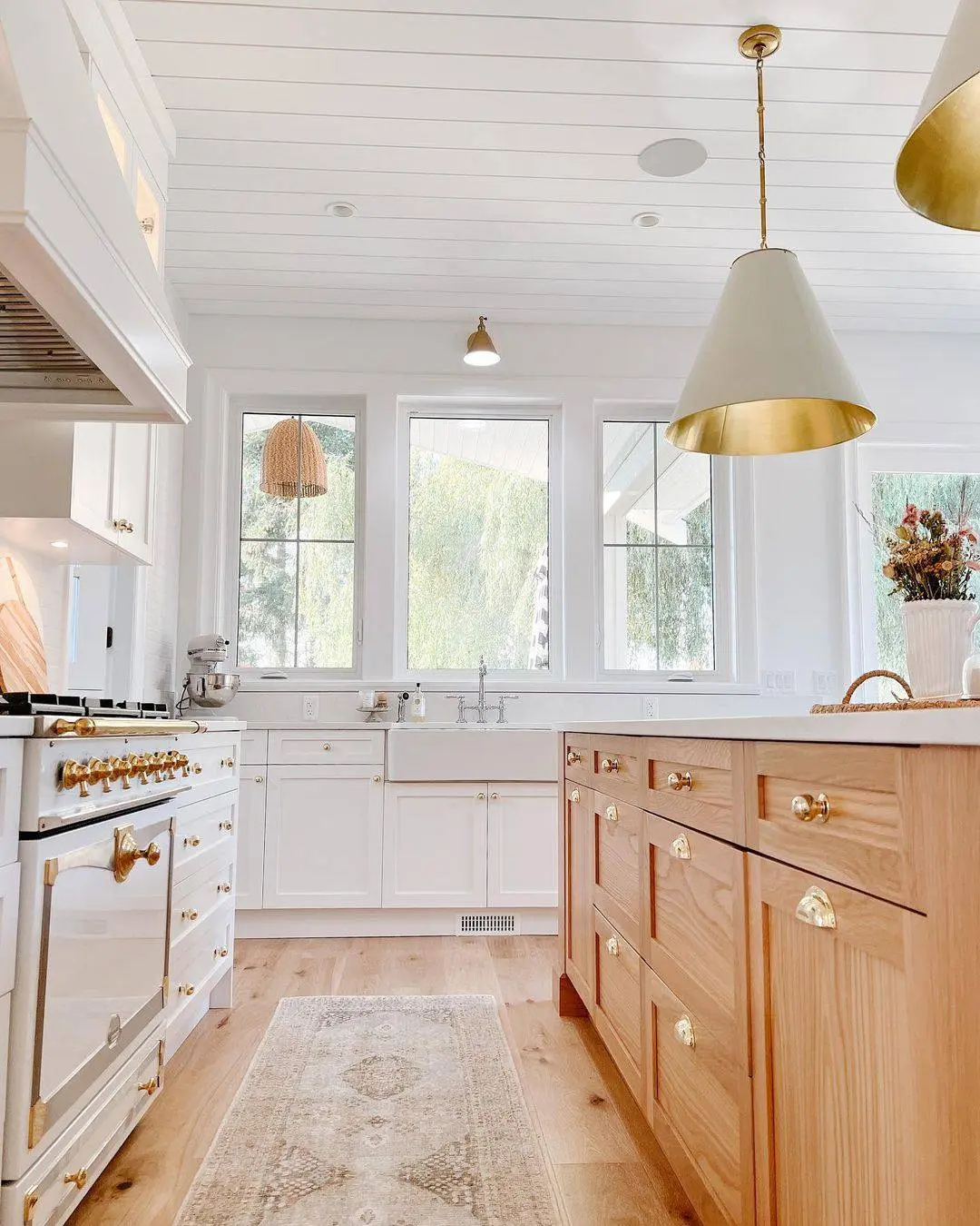 Warm Wood Island Mixes Cabinet Doors and Drawers with Brass Hardware