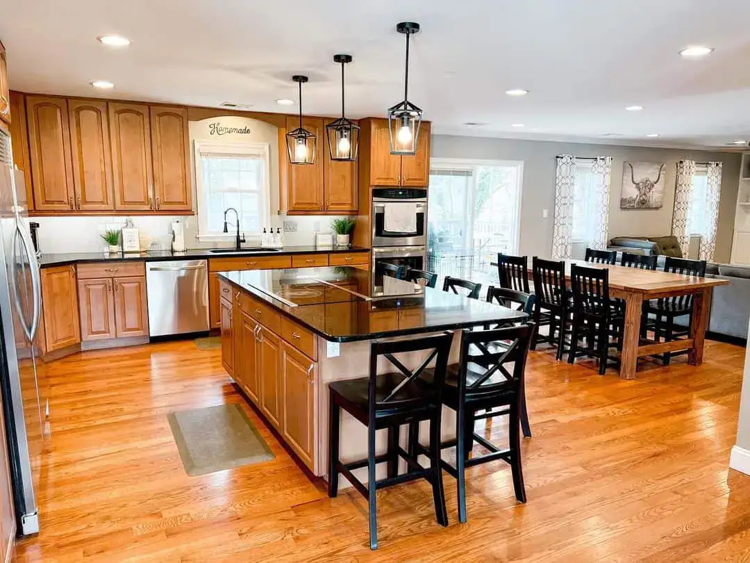 Warm Wood Cabinets With Simple Black Hardware