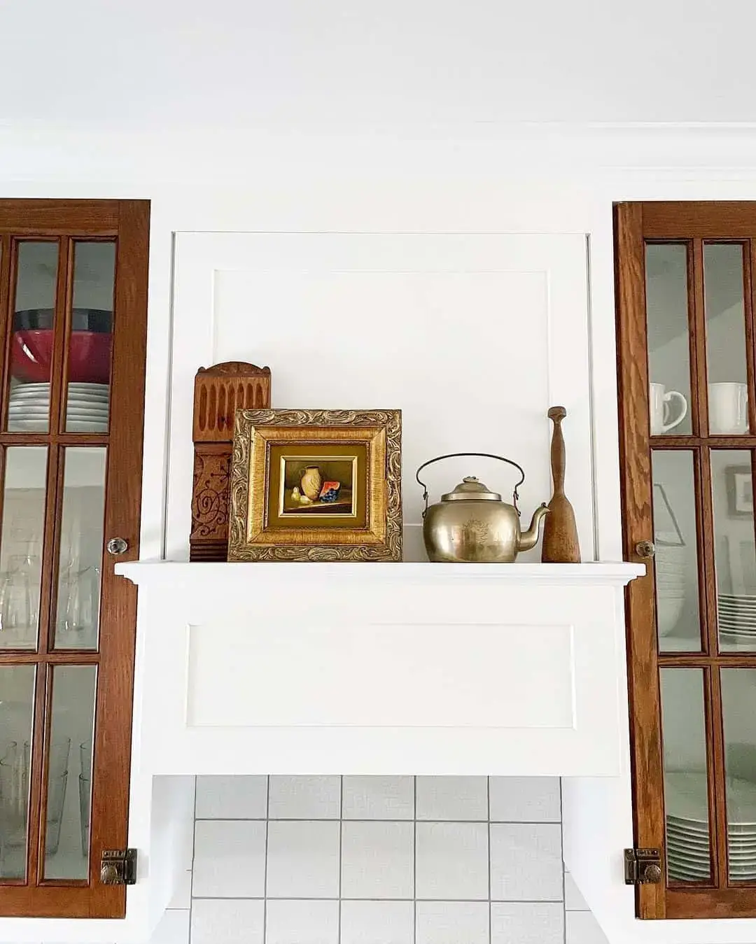 Ornate Wood Frame Adds Artful Interest Above the Range