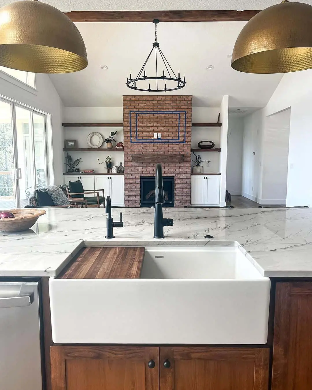 Warm Wood Cabinets Contrast With a Brick Fireplace and Open Shelving