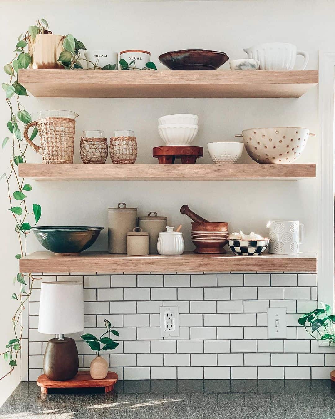 Oak Shelves Display Labeled Kitchen Canisters and Mixing Bowls