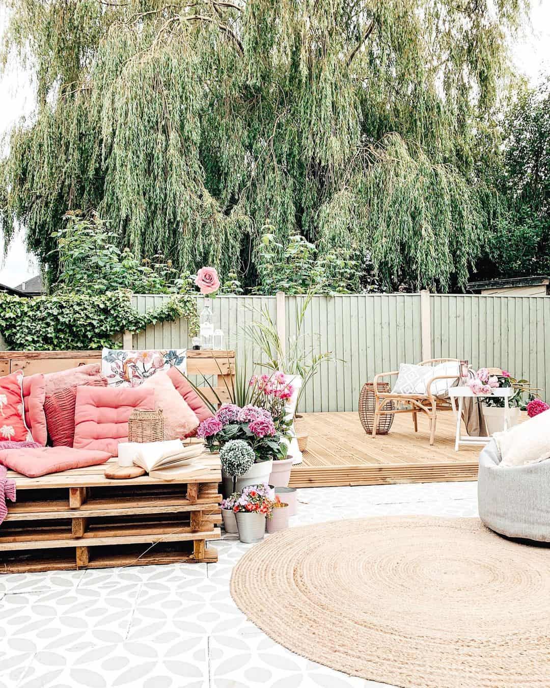 Stacked Pallet Sofa With Plush Pink Cushions Creates A Cozy Lounge