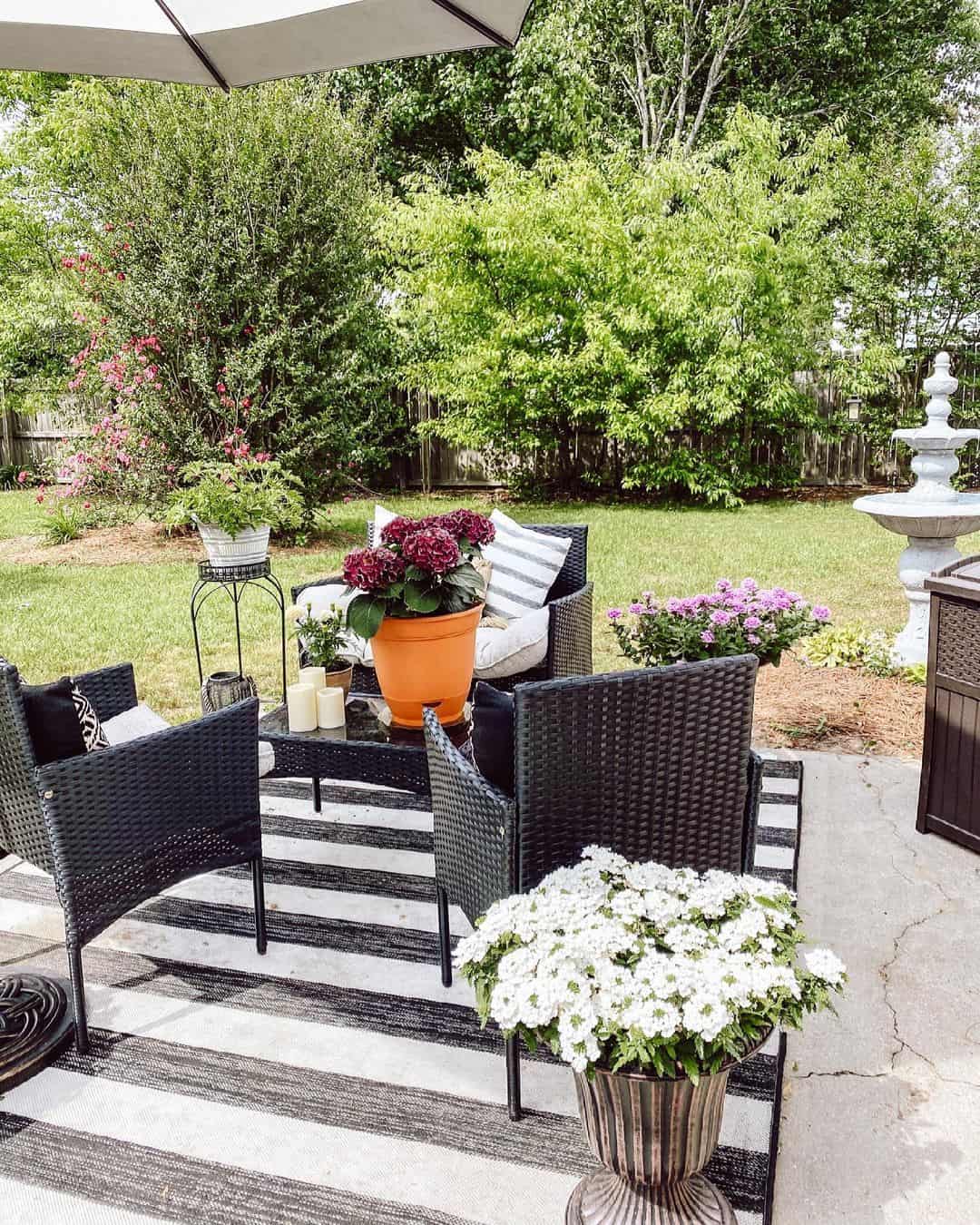 Define Seating with Black Wicker Chairs on a Striped Rug