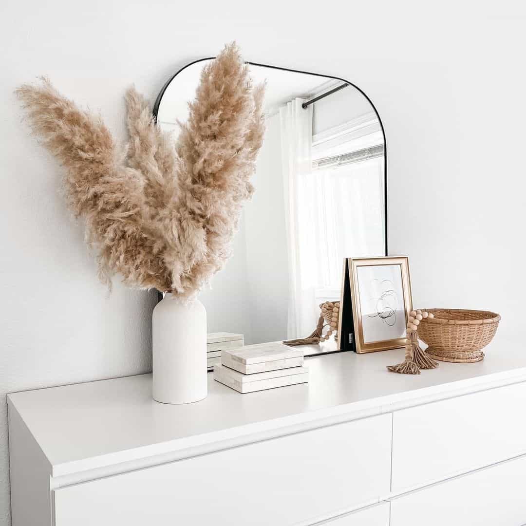 Tall dried pampas grass adds airy texture to a minimalist vase