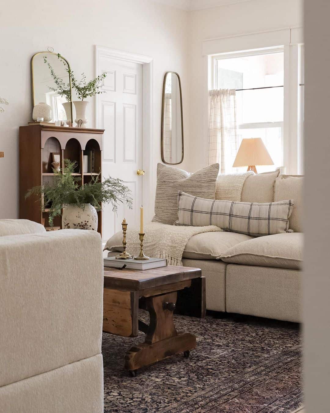 Tall Oval Mirror Adds Vertical Accent Above Cabinet