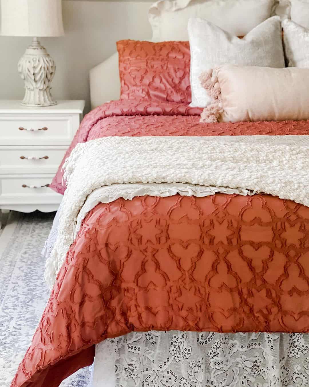 Textured Red Bedding With a Delicate Lace Skirt