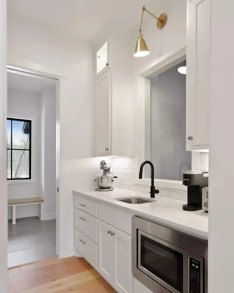 Adjustable Brass Sconce Illuminates Kitchen Counter