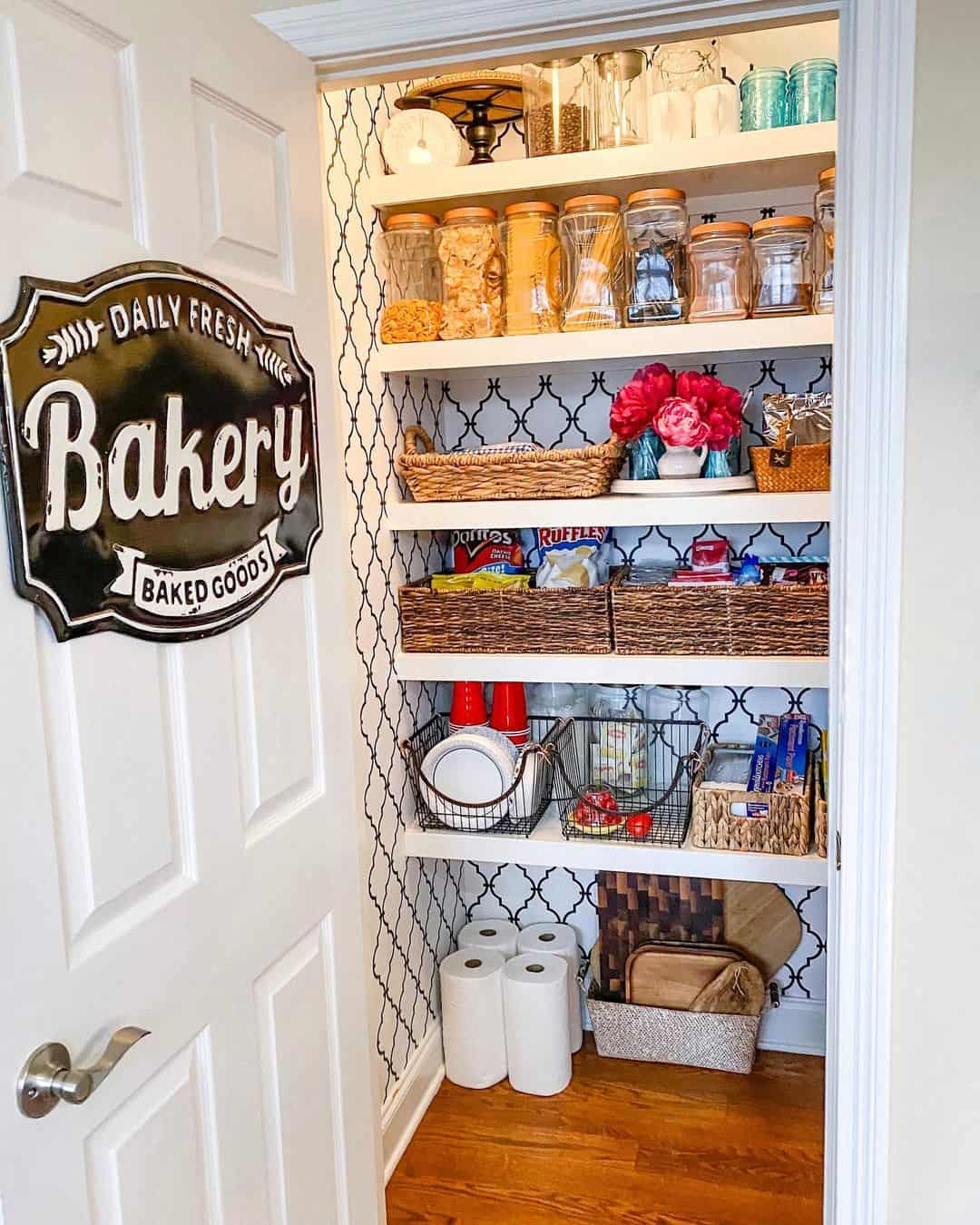 Black and white trellis wallpaper adds pattern to pantry shelves