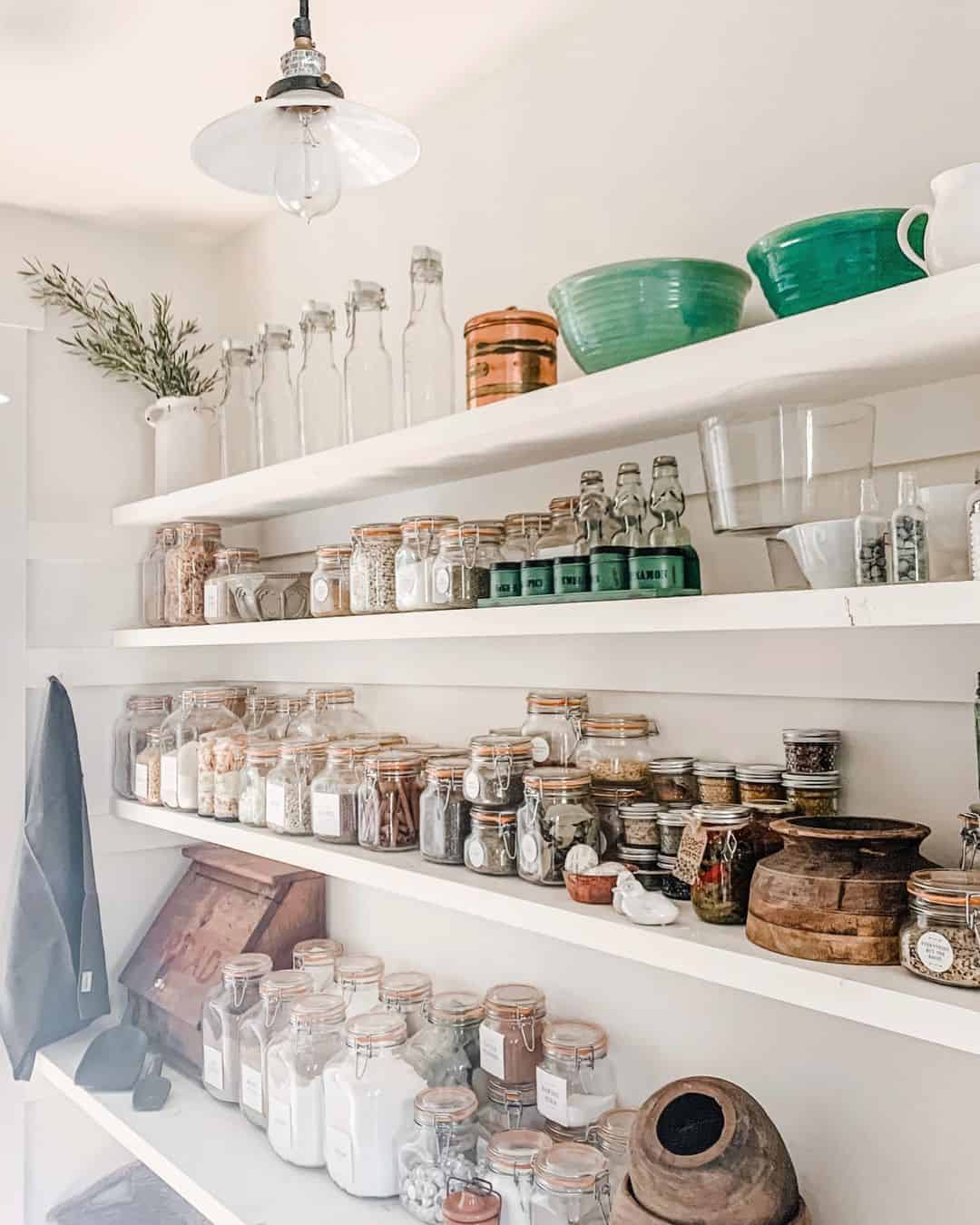 Glass Jars With Orange Lids Organize Dry Goods in Rows