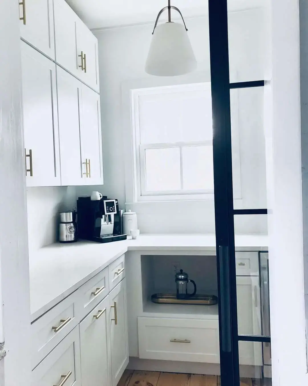 Streamline Your Pantry with White Cabinets and Gold Pulls
