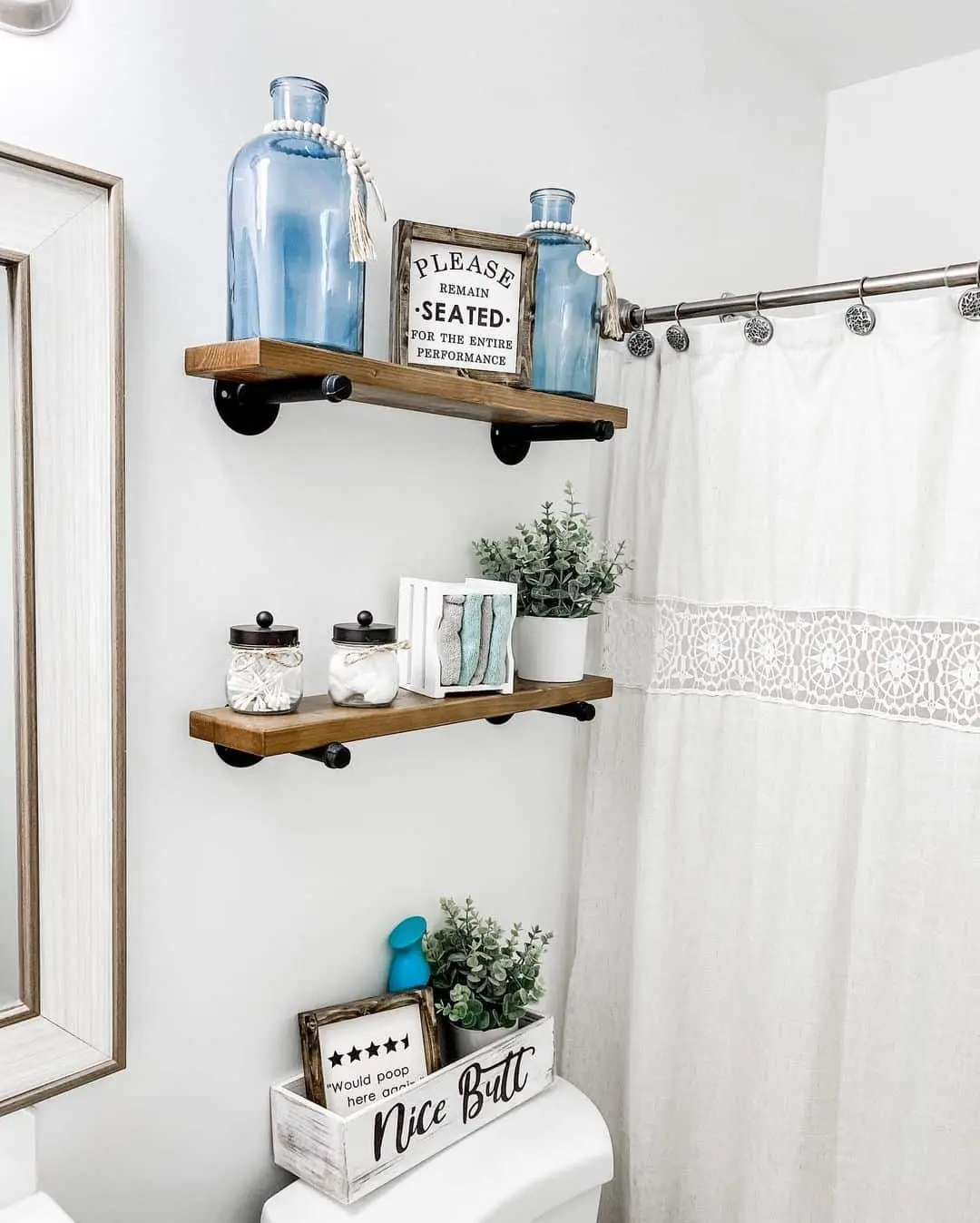 Blue Glass Bottles Add a Pop of Color Above the Toilet