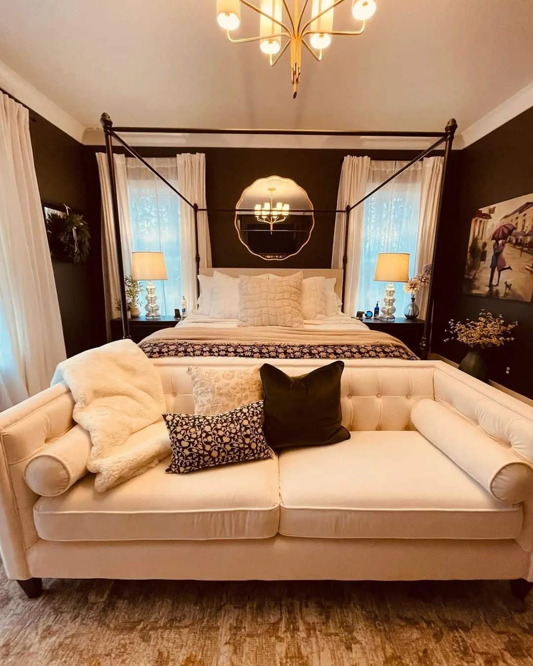 Scalloped Mirror Reflects Chandelier Light Above Bed