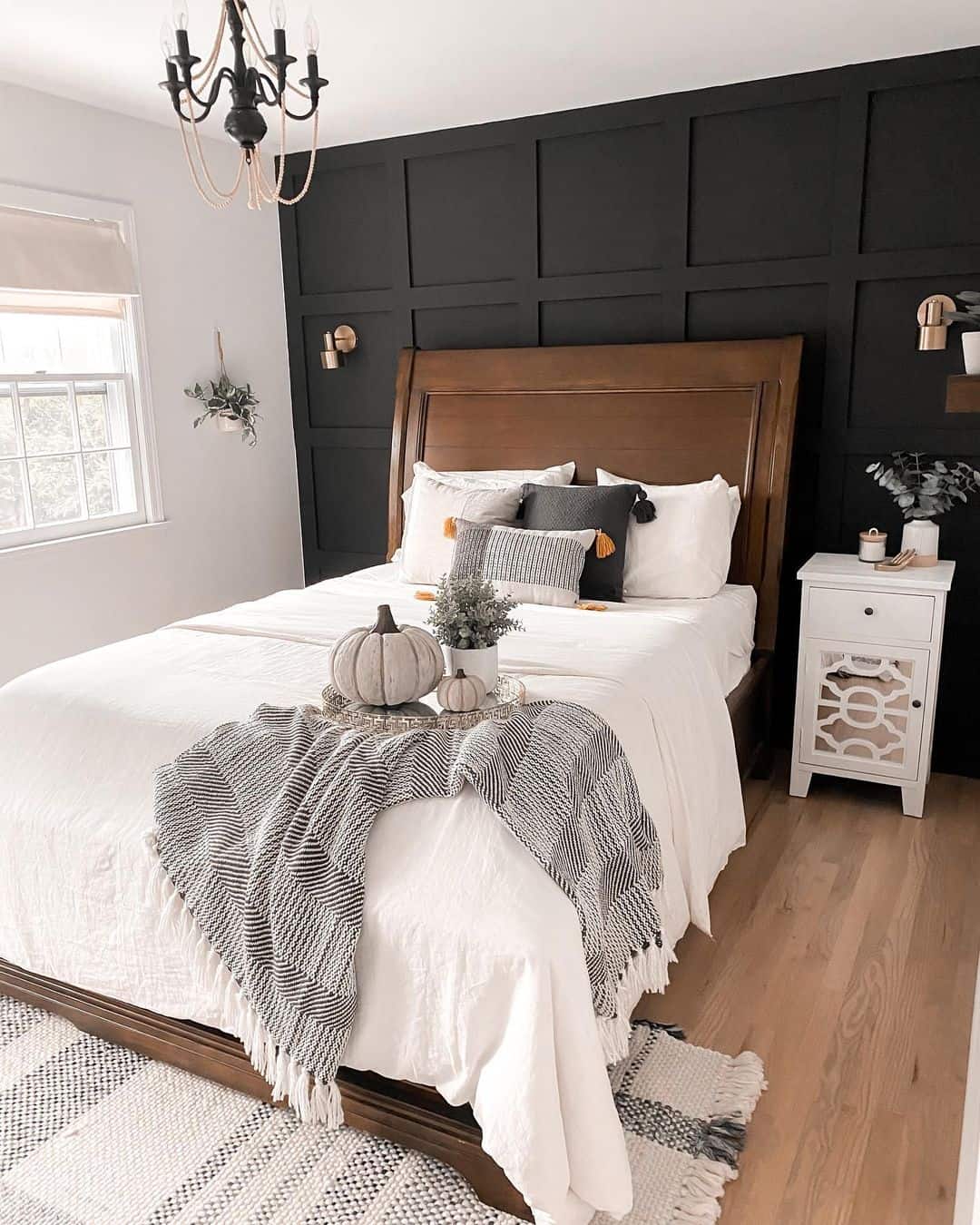 Dark Grid Paneling Frames a Cozy, Layered Bed