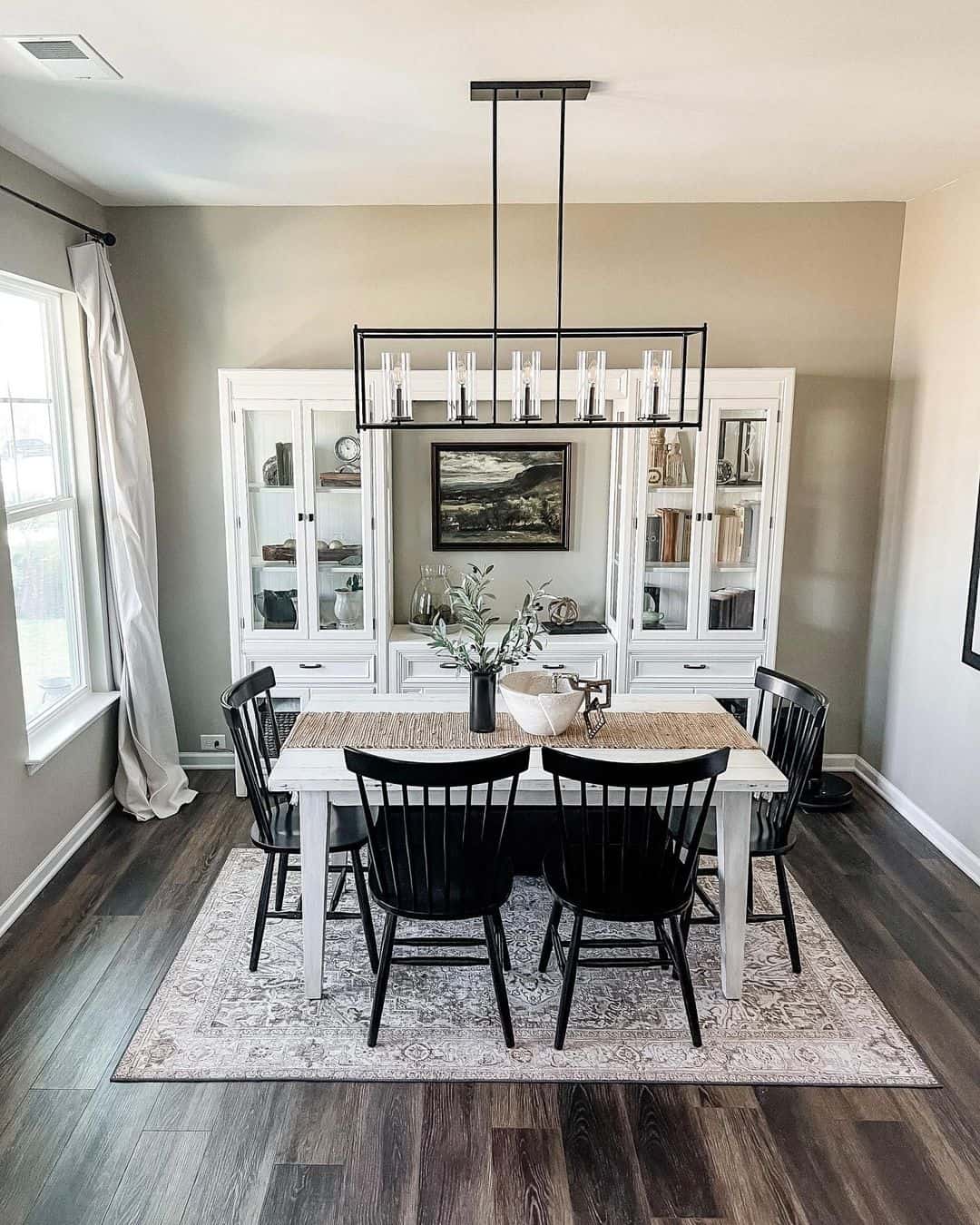 White Display Cabinets Frame a Landscape Artwork