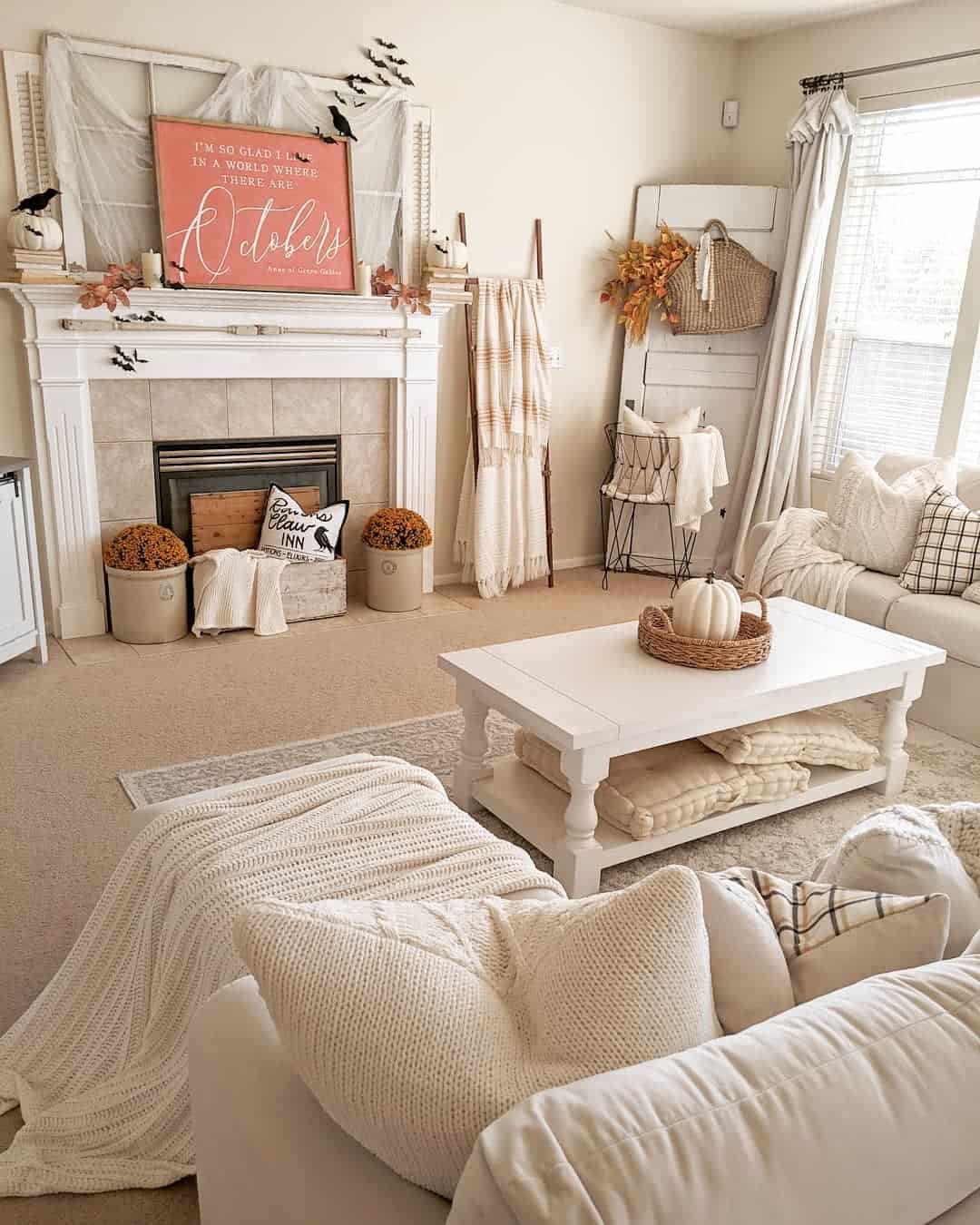 Wooden ladder displays cozy throws near fireplace