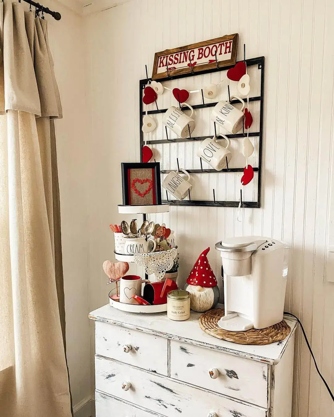 Black metal rack displays festive hearts and Rae Dunn mugs