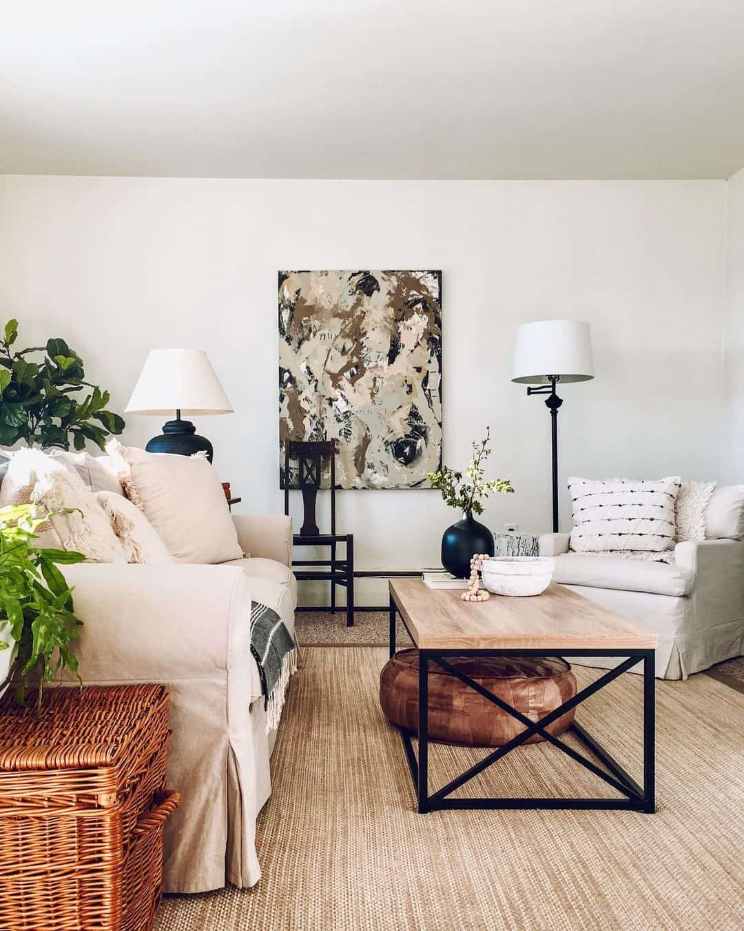 Abstract Artwork Adds a Moody Focal Point Above a Neutral Sofa