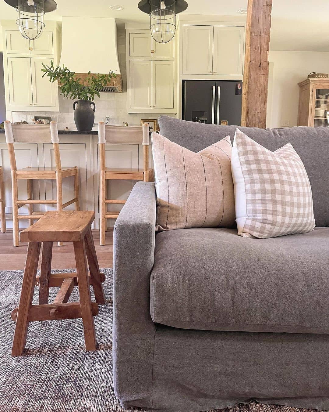 Striped and Gingham Pillows Add Subtle Pattern to Your Dark Sofa