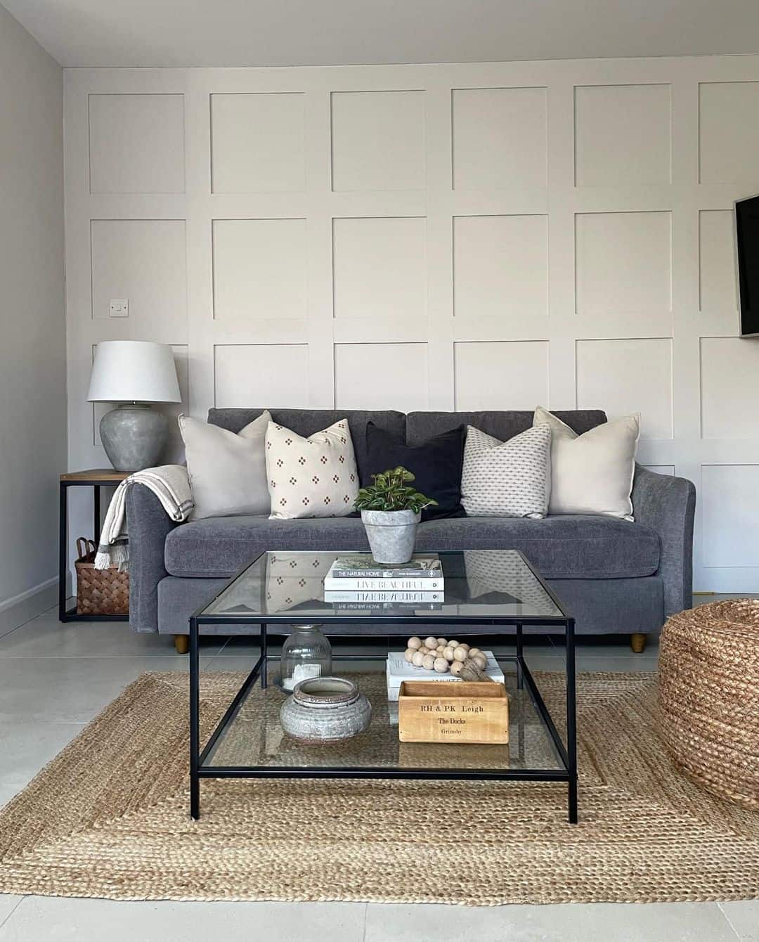 Paneled Wall Adds Architectural Interest Behind Your Dark Grey Sofa