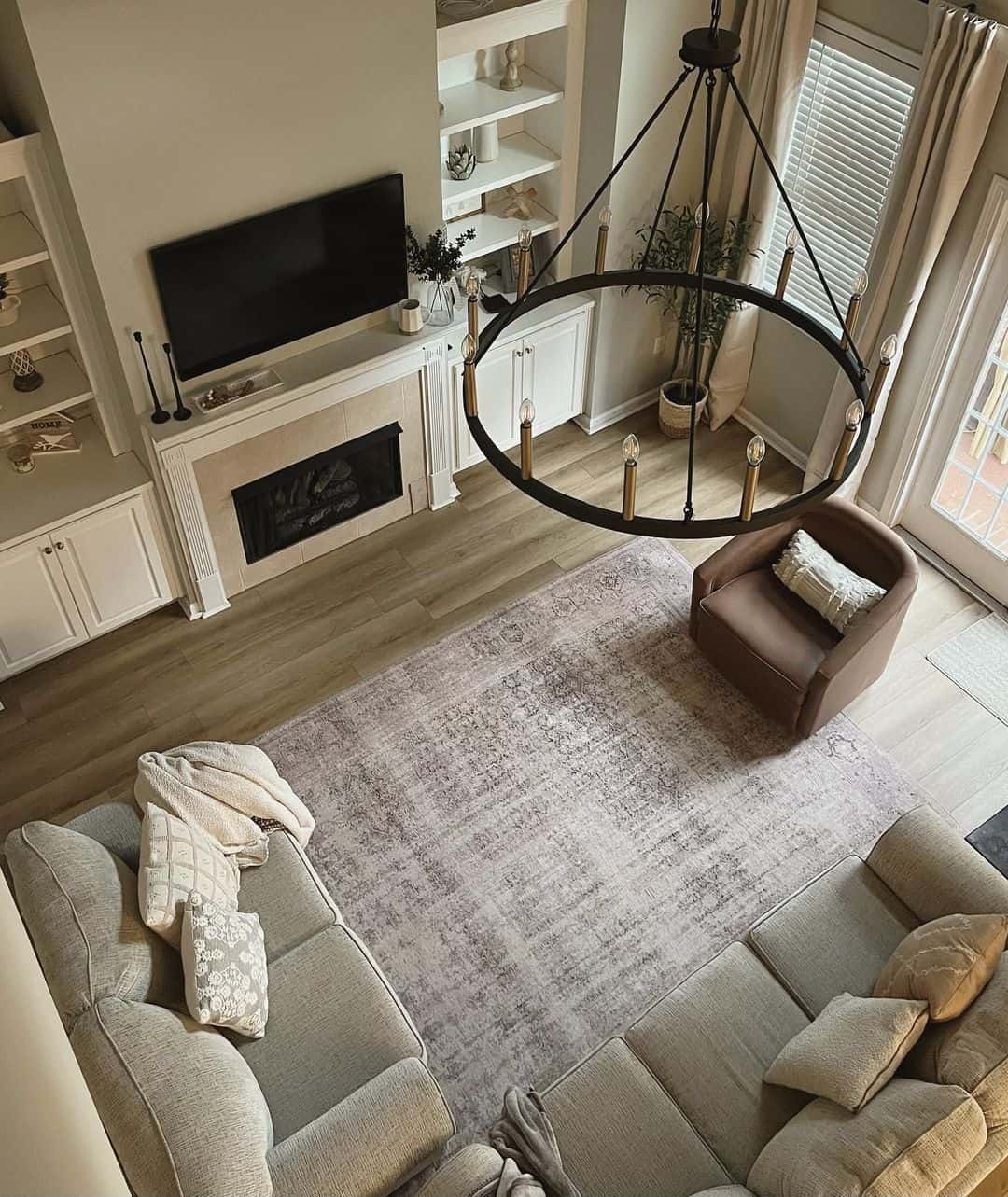 Round Chandelier Adds Dramatic Scale Above Seating Area