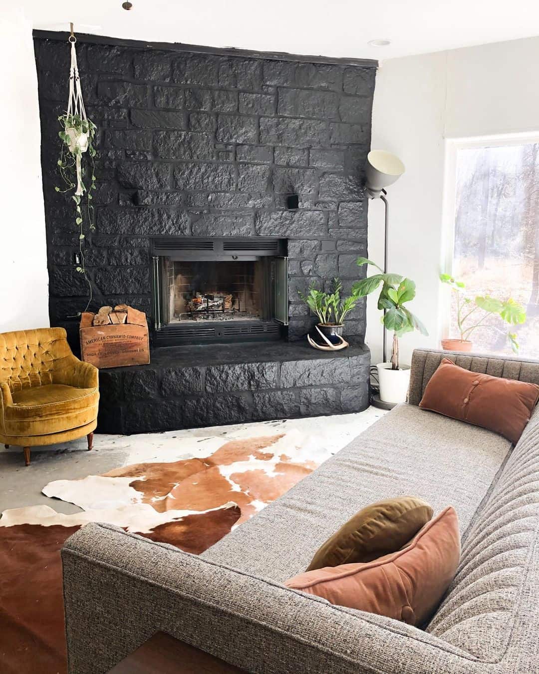 Wooden Crate Holds Firewood Near a Black Stone Fireplace