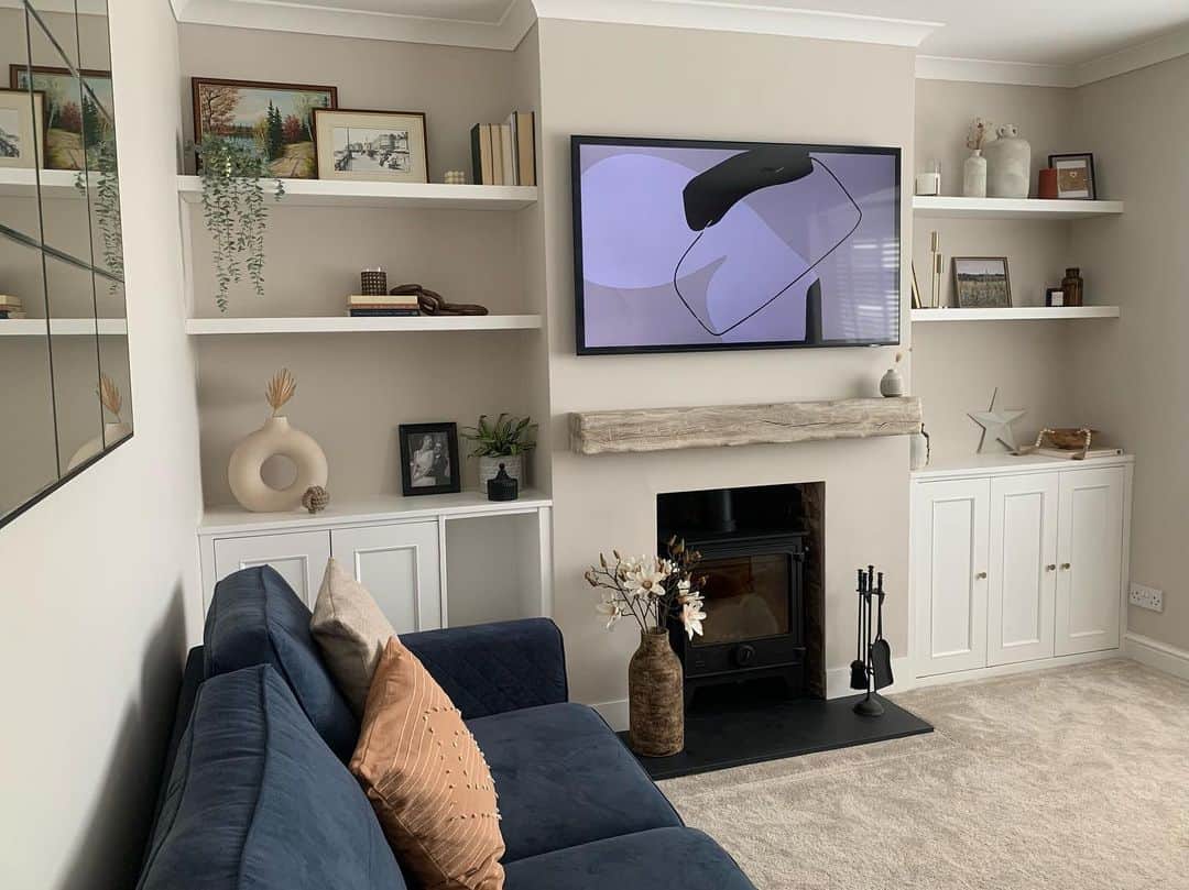 Floating Shelves Frame Art and Greenery Above Built-In Cabinets