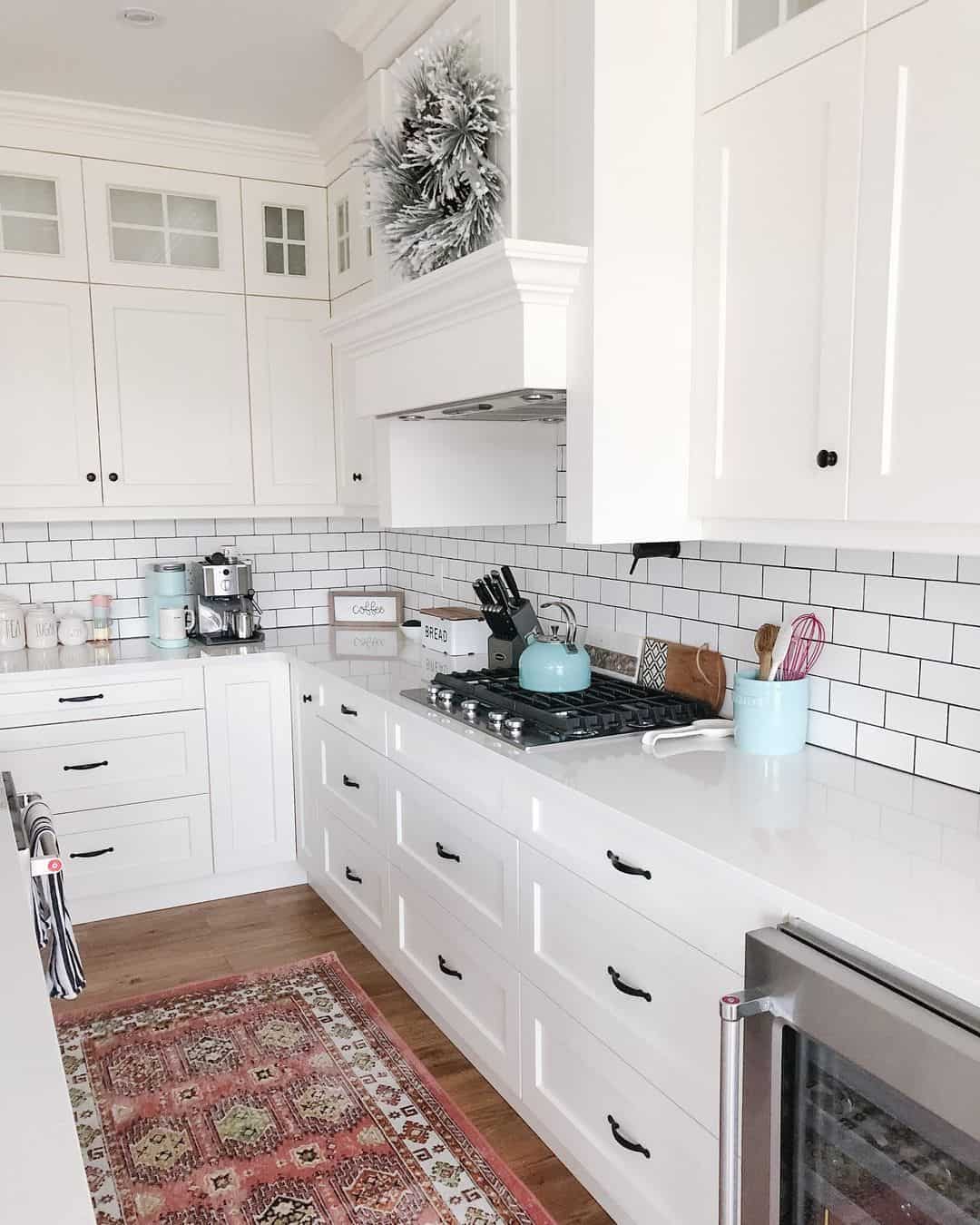 Frosted Garland Adds Winter Charm Above White Range Hood