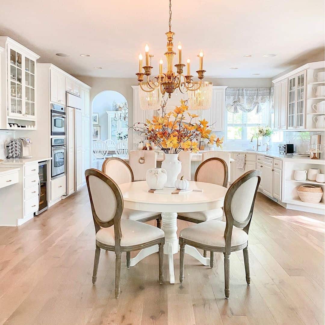 Round White Pedestal Table With Sculptural Fall Centerpiece