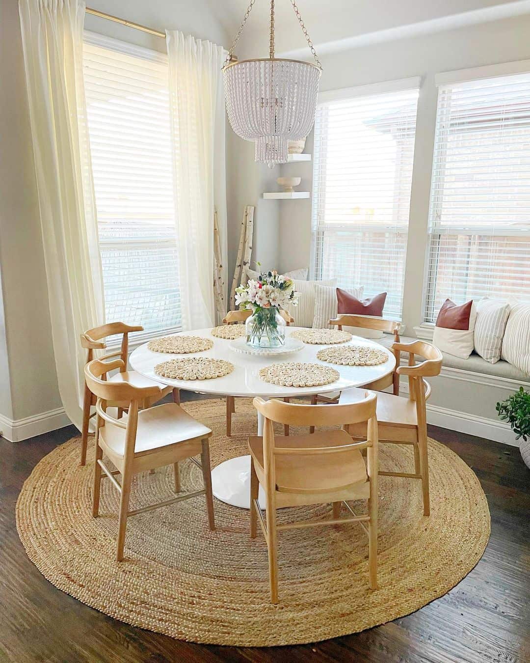 Round Jute Rug Under Simple Wood Chairs