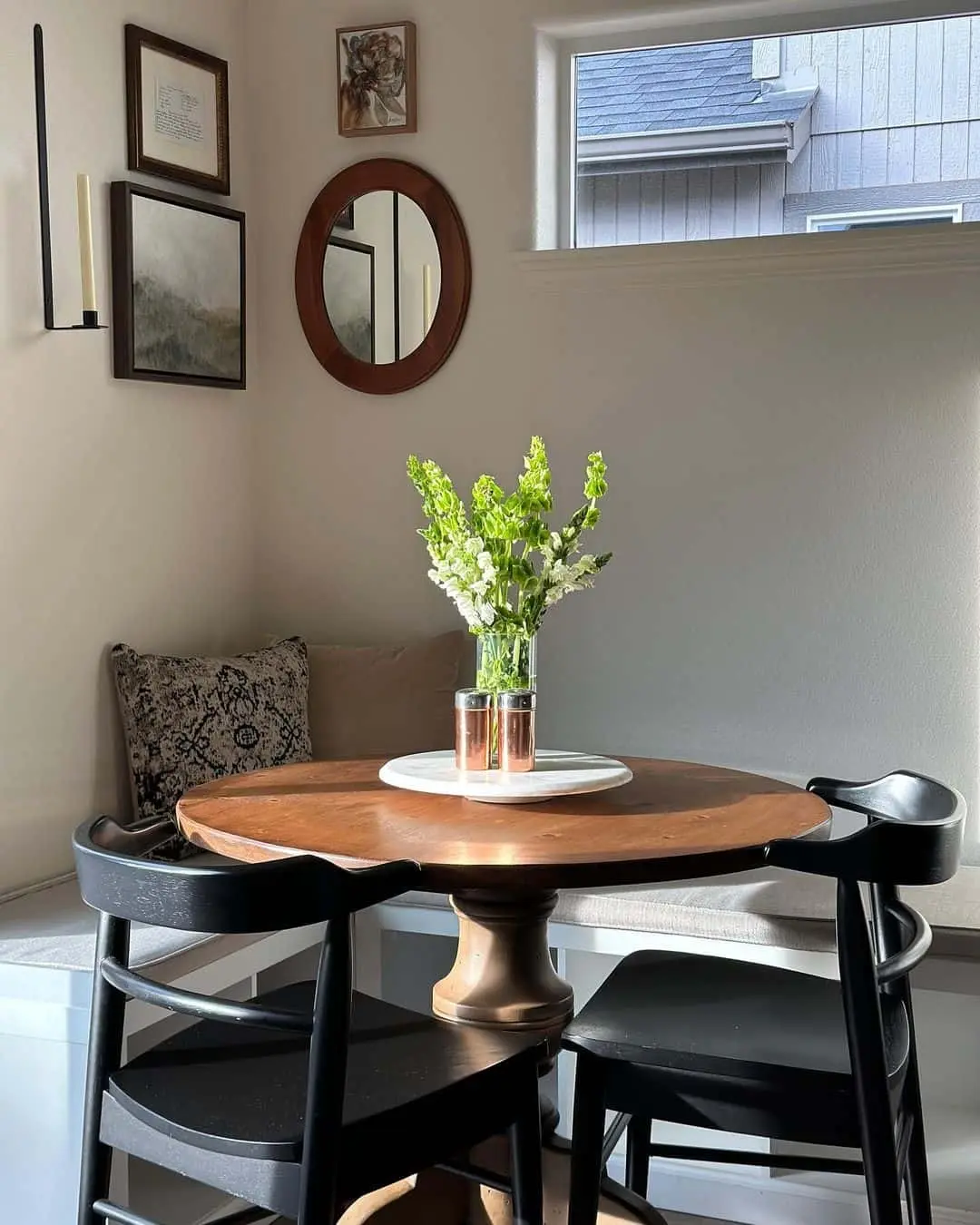 Gallery Wall of Art Adds Personality Above Built-In Seating