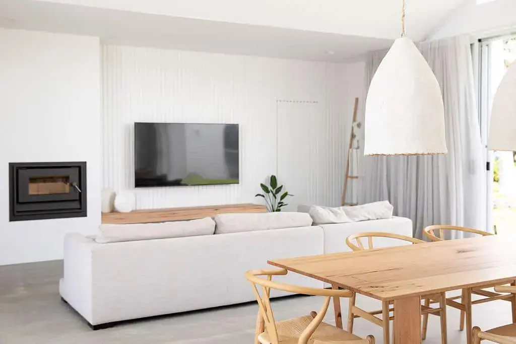 Black Fireplace Insert Offers a Sleek Contrast Against White Walls