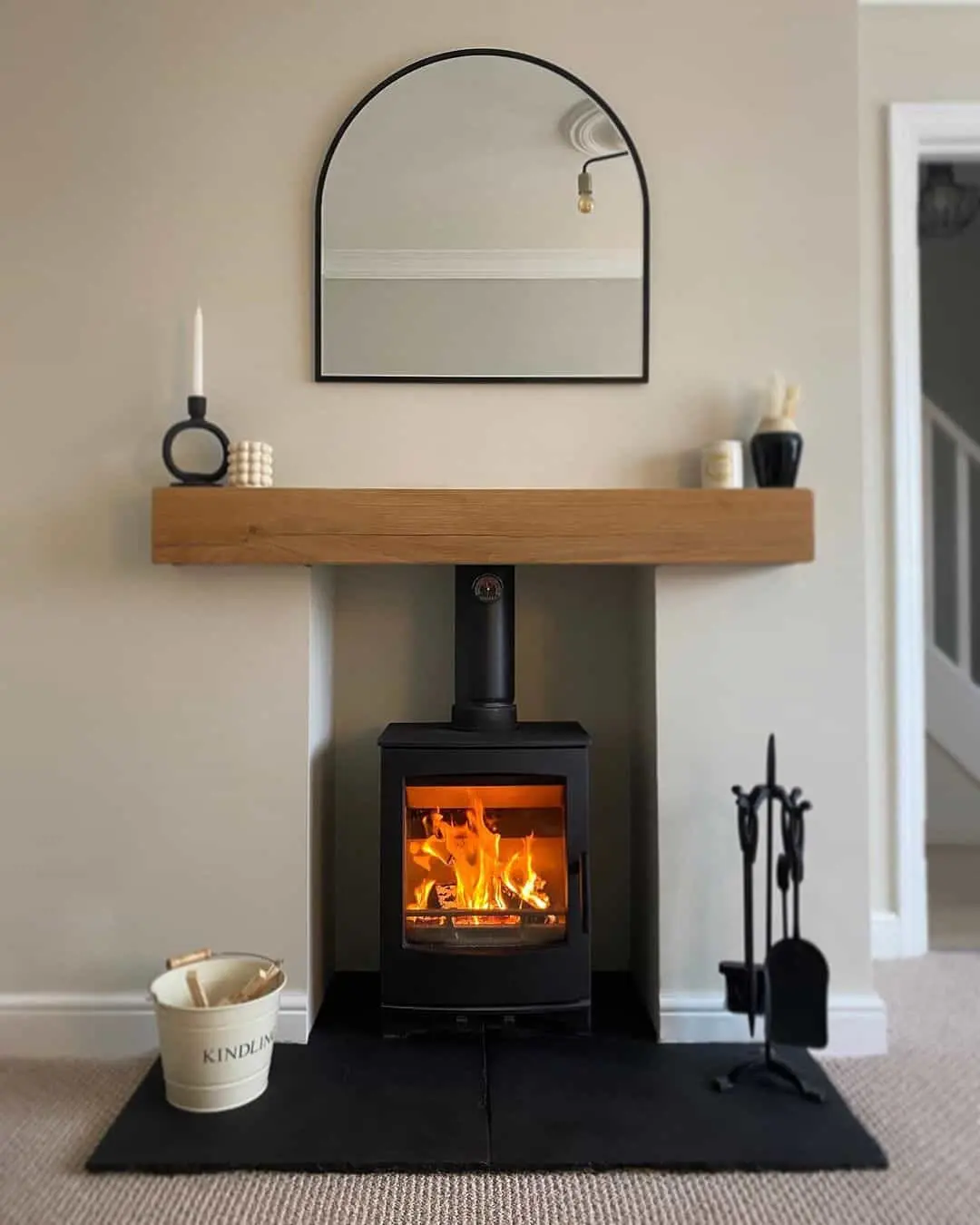 Arched Mirror Above Wood Mantel Softens the Fireplace Design