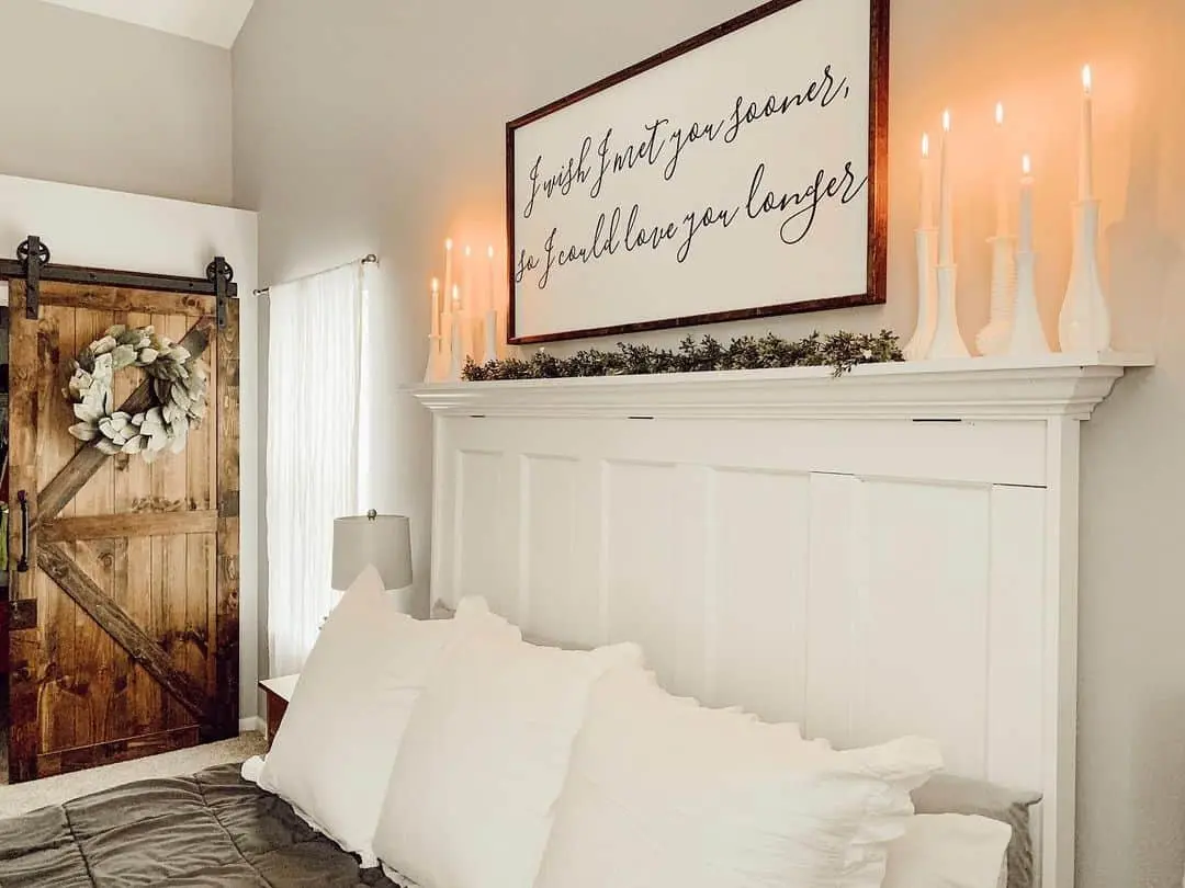 White Bud Vases Mimic Candlelight Above the Bed