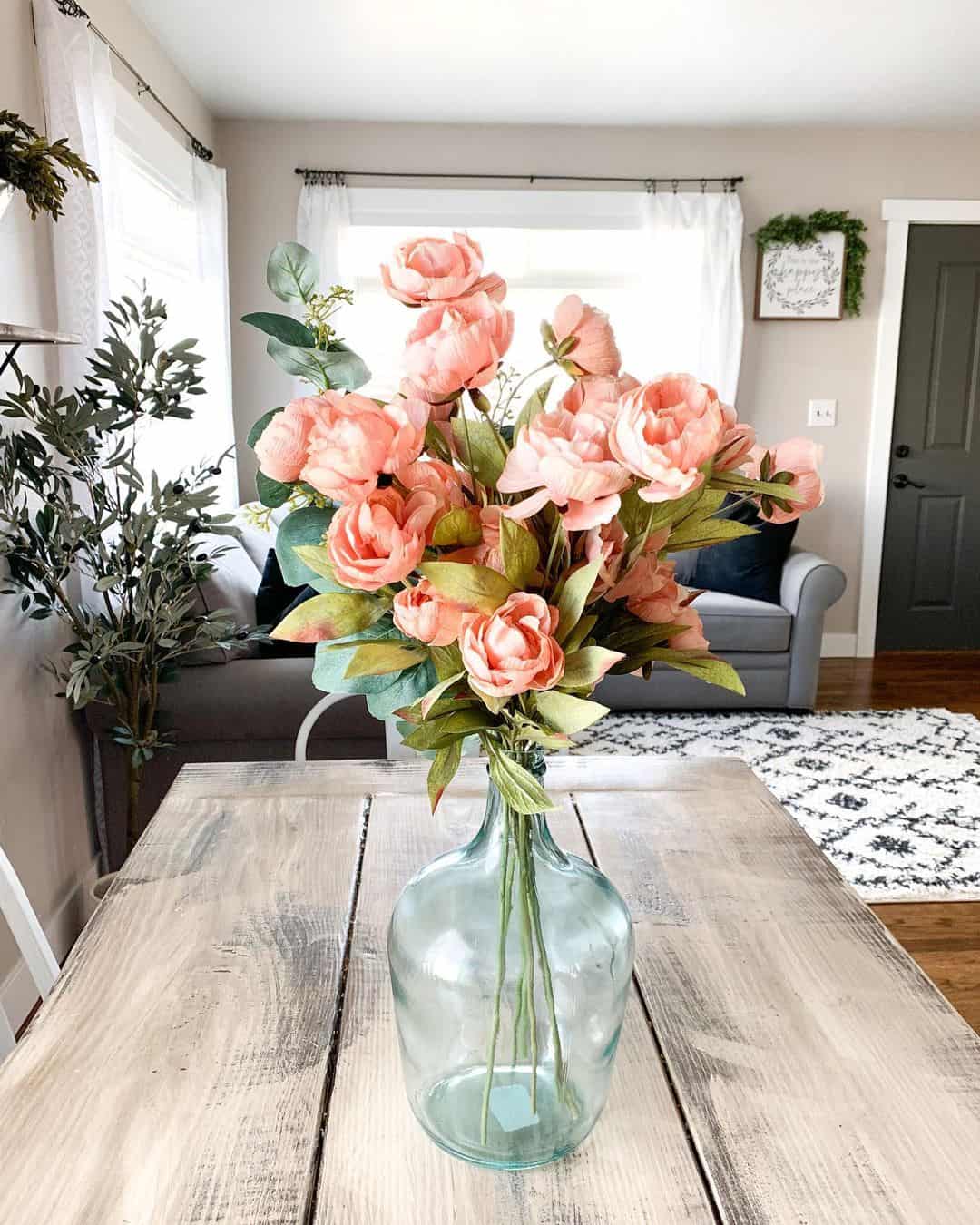 Showcase Peonies in a Large Glass Bottle Vase