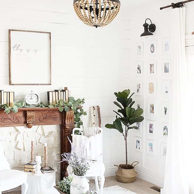 Gallery Wall of Small White Frames Creates a Cozy Corner