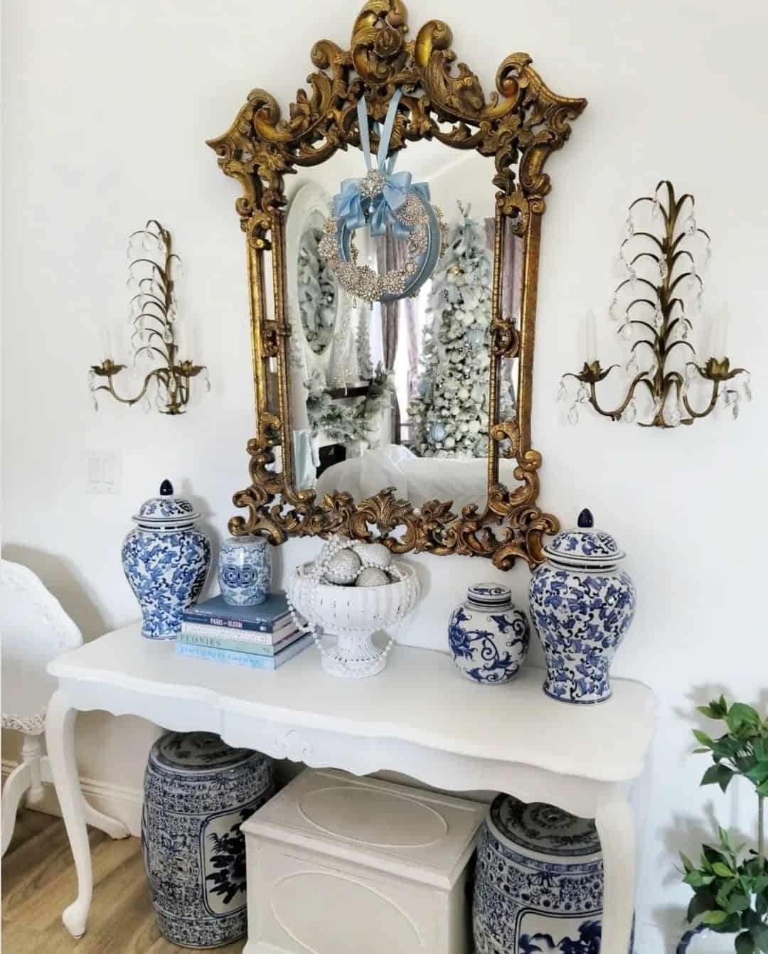 Ornate Gold Mirror Reflects Festive Trees and Blue and White Vases