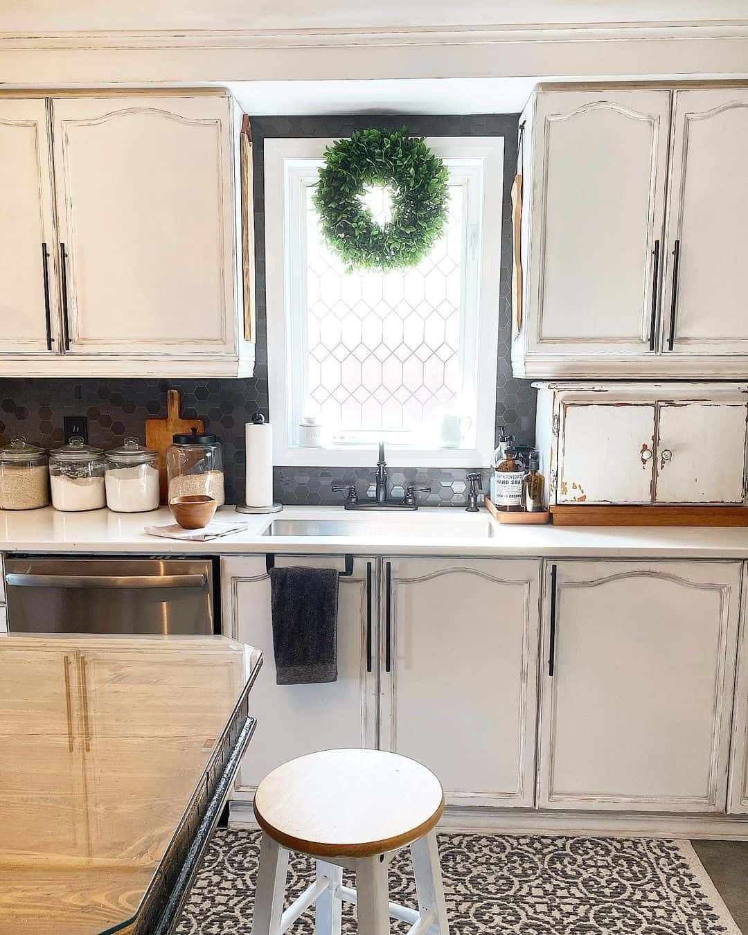 Boxwood Wreath Adds Seasonal Greenery to Kitchen Window