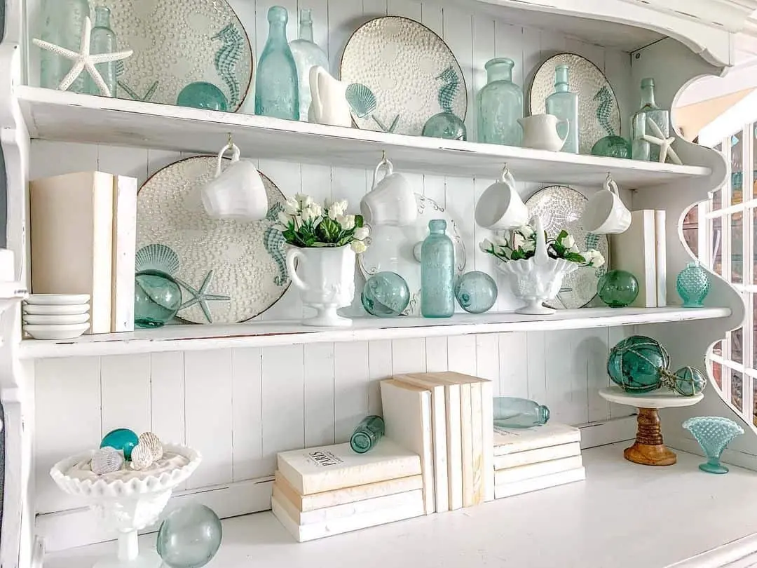 Seashells and glass floats create a beachy vignette