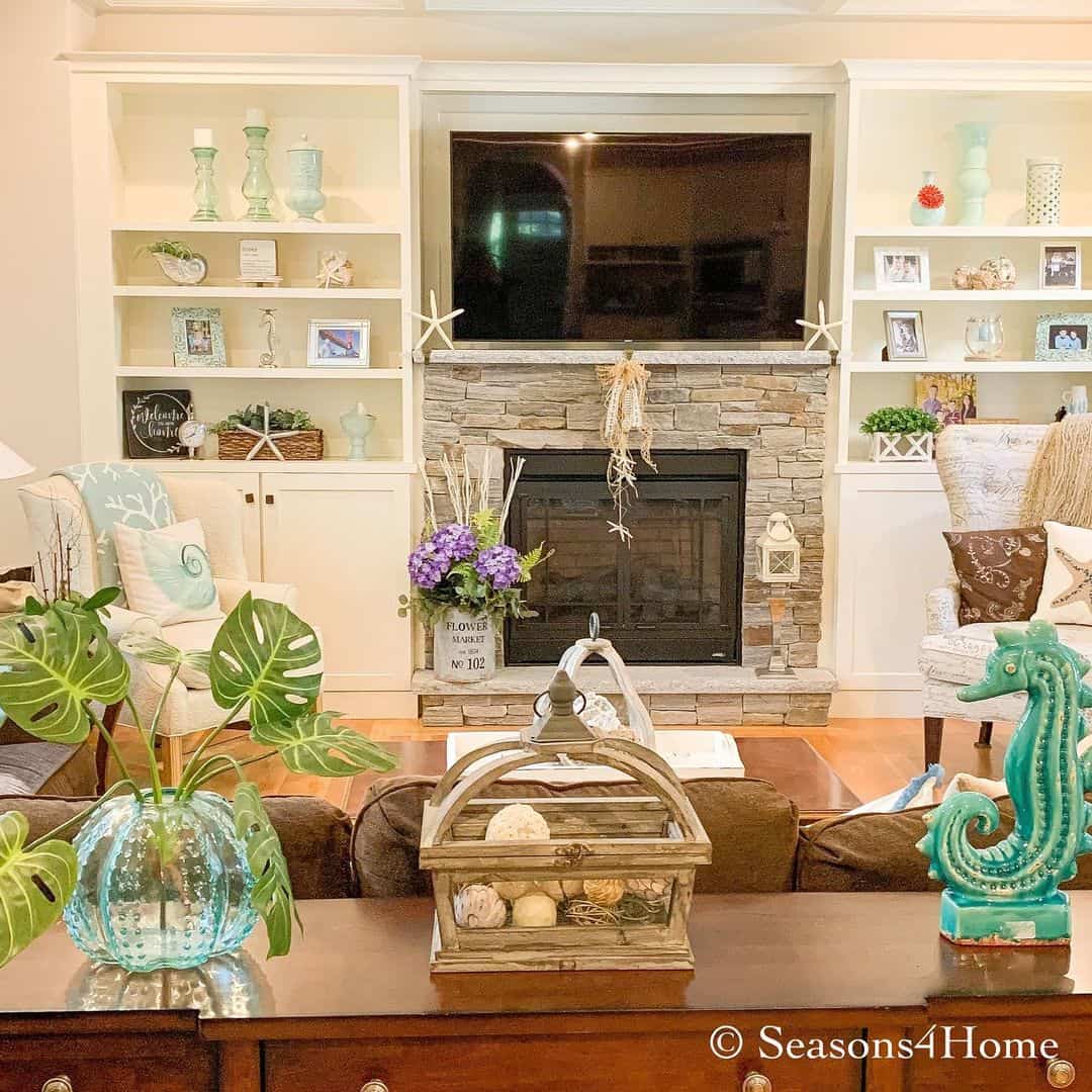 Seashells and sea sponges fill a rustic wooden lantern