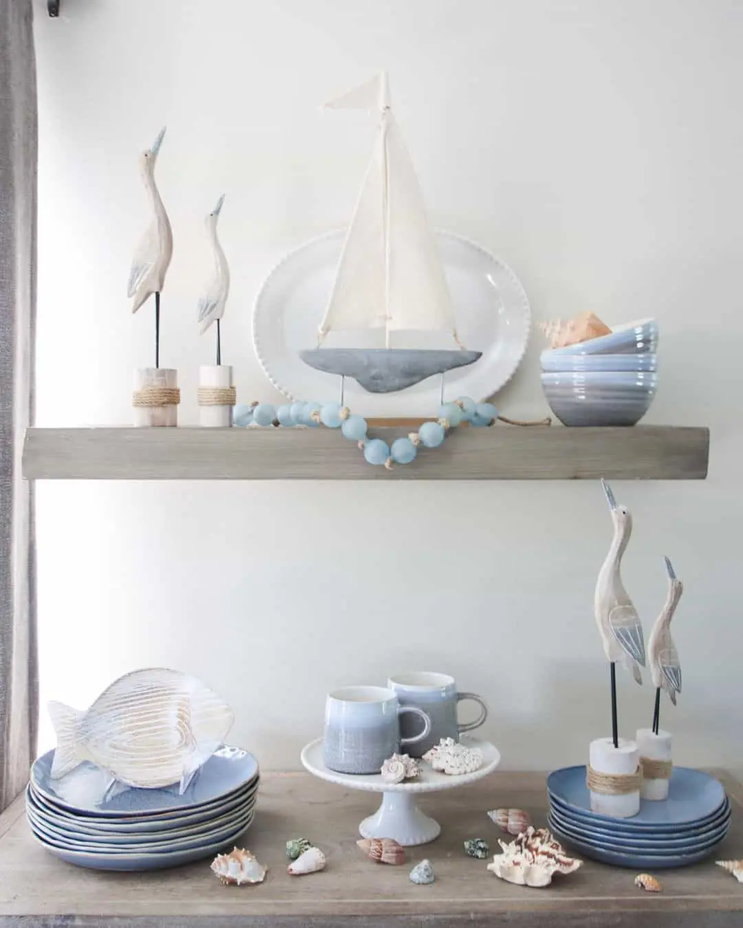 Wooden bird sculptures stand tall on twine-wrapped bases