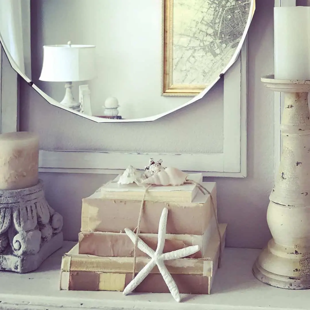 Stack of vintage books tied with twine and adorned with a starfish