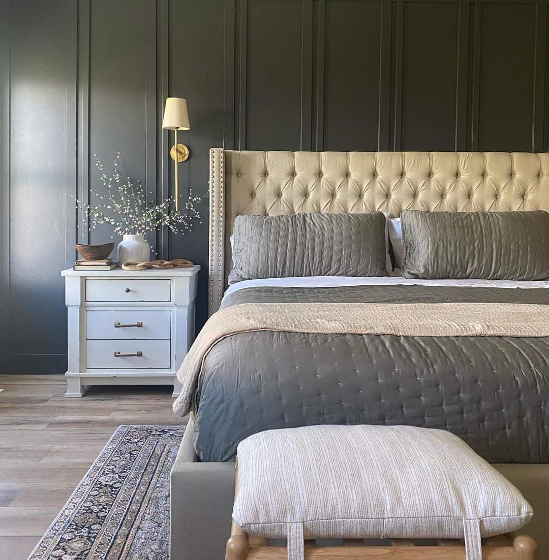 Dark Paneled Walls Create a Dramatic Backdrop for a Tufted Headboard