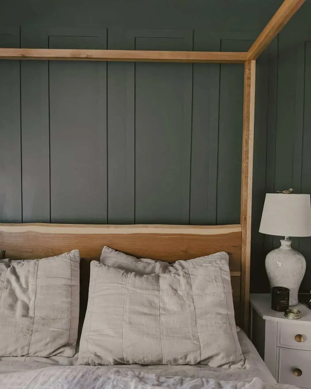 Contrast Dark Paneled Walls With a Wood Canopy Bed Frame