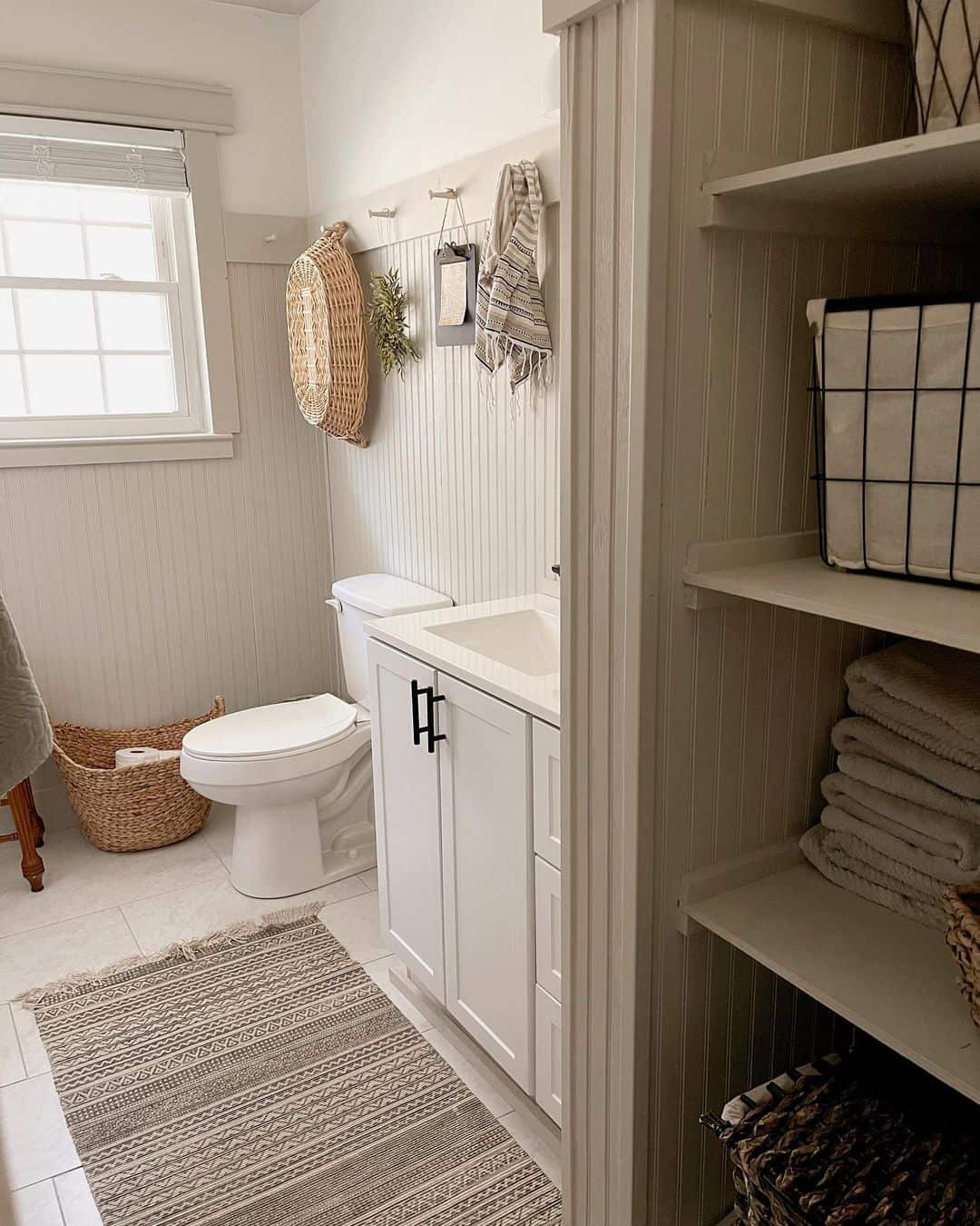 Oversized Woven Basket Adds Organic Texture Above Toilet