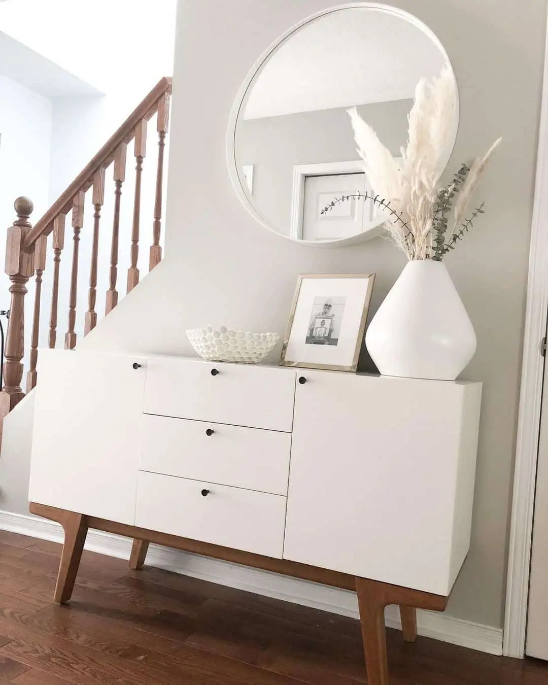 Tall white vase with pampas grass creates a delicate focal point